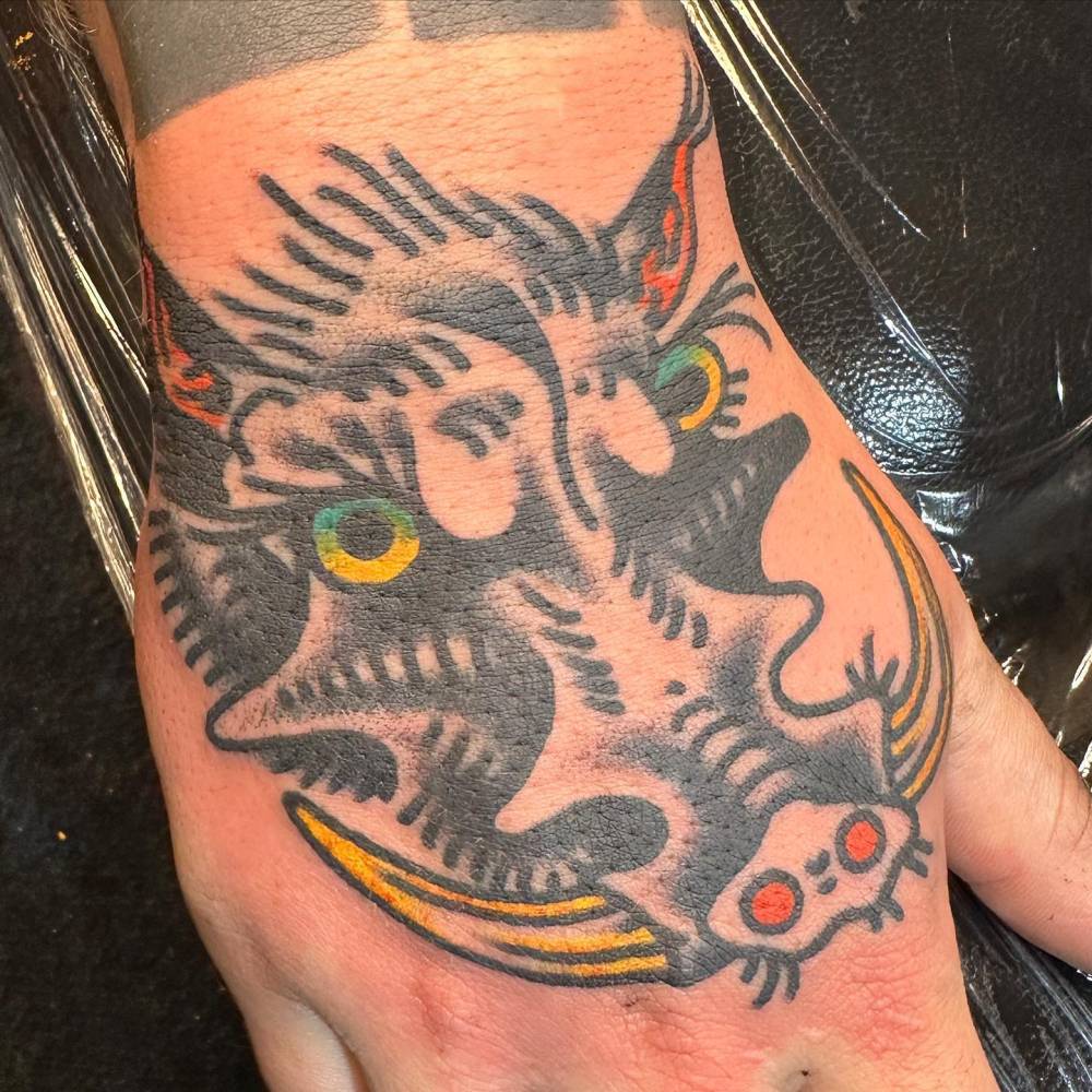 Wild pig tattoo located on the hand, done in traditional style.