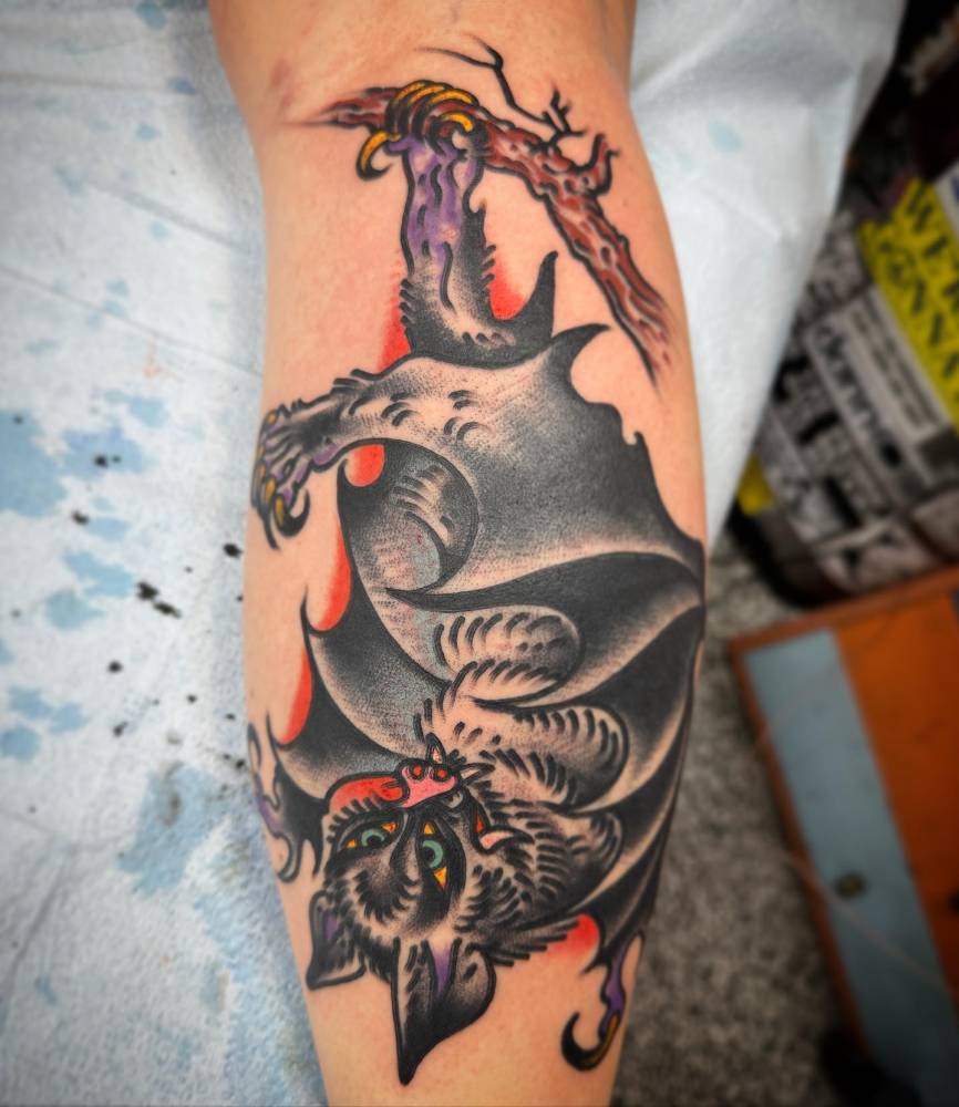 Bat tattoo located on the calf, done in traditional style.