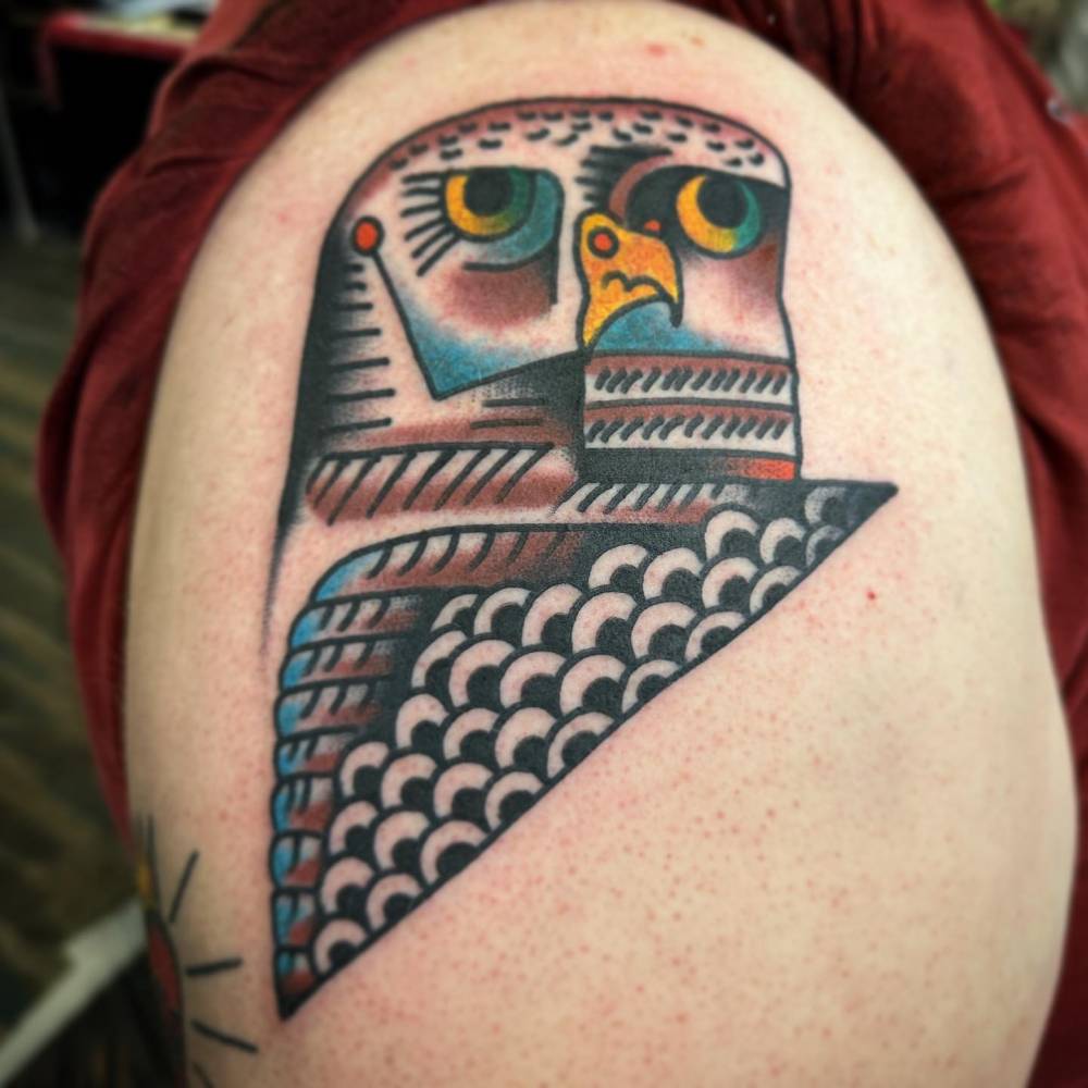 Picasso inspired owl tattoo located on the upper arm.