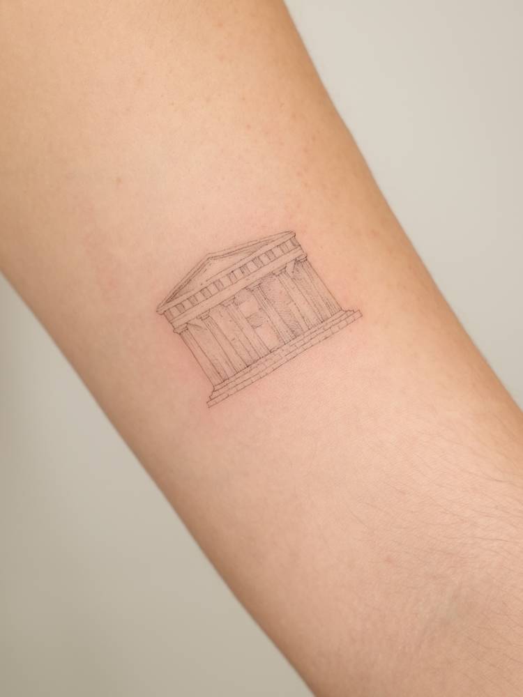 Parthenon tattoo in fine line style located on the bicep.