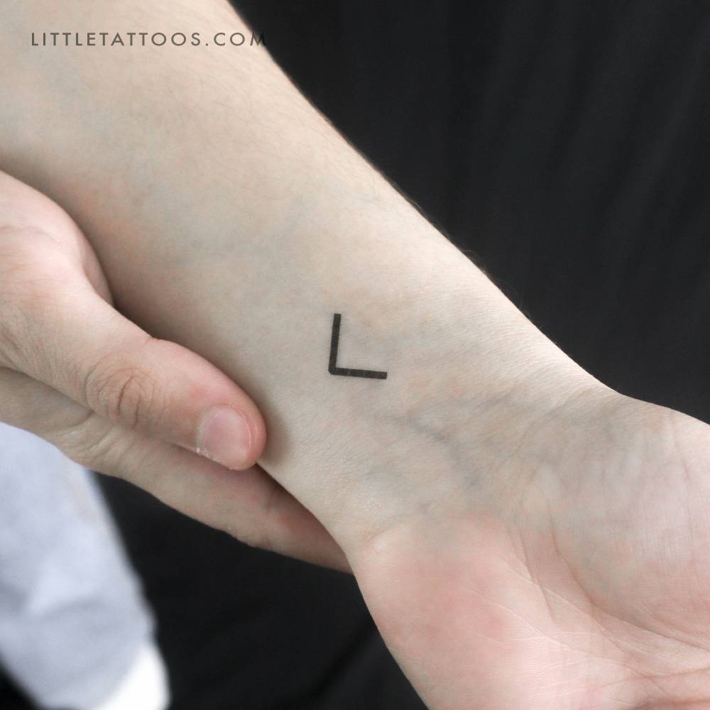 Minimalist Kenaz temporary tattoo located on the wrist.