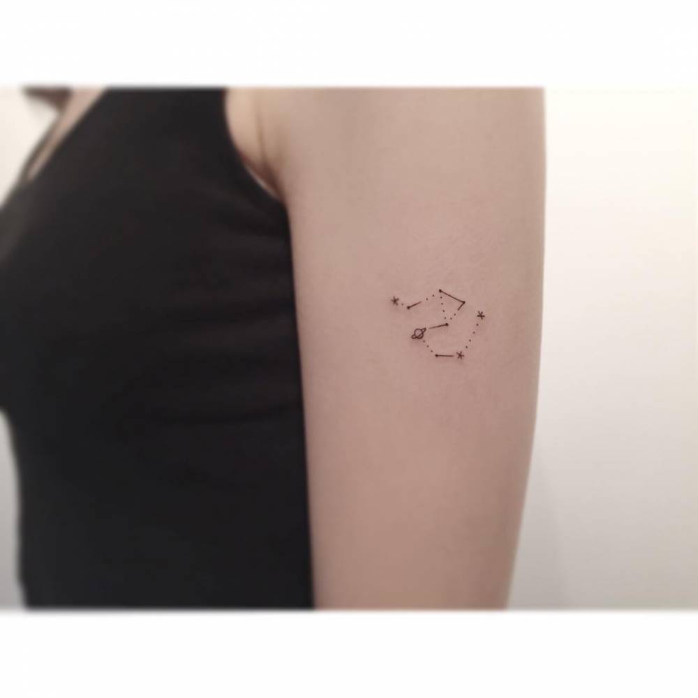 Libra and Aquarius constellations tattooed on the upper arm.