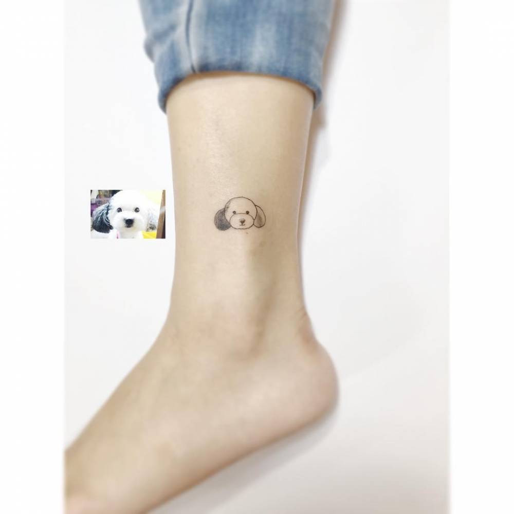 Poodle portrait tattoo in minimalist style done on the ankle.