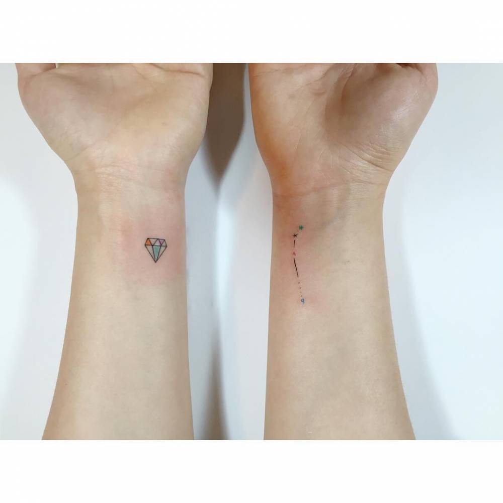 Diamond and Aries constellation tattoos located on the wrist.