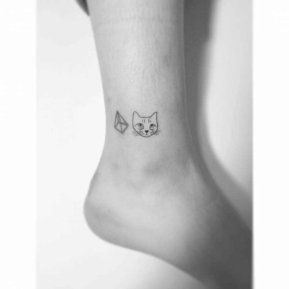 Tiny cat portrait tattoo in fine line style located on the ankle.