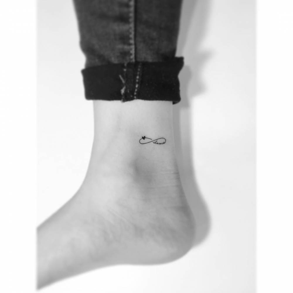 Minimalist style infinity symbol, heart and word "dance" tattoo.