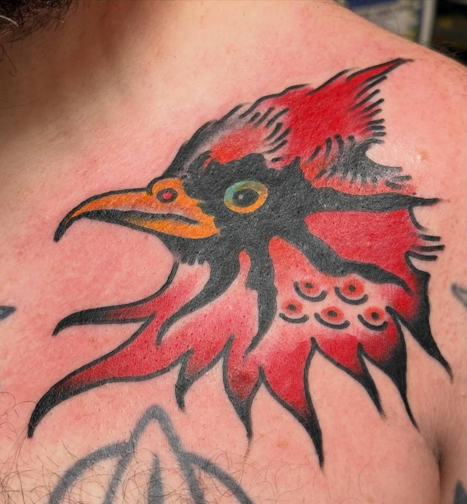 Cardinal portrait tattoo in traditional style located on the chest.