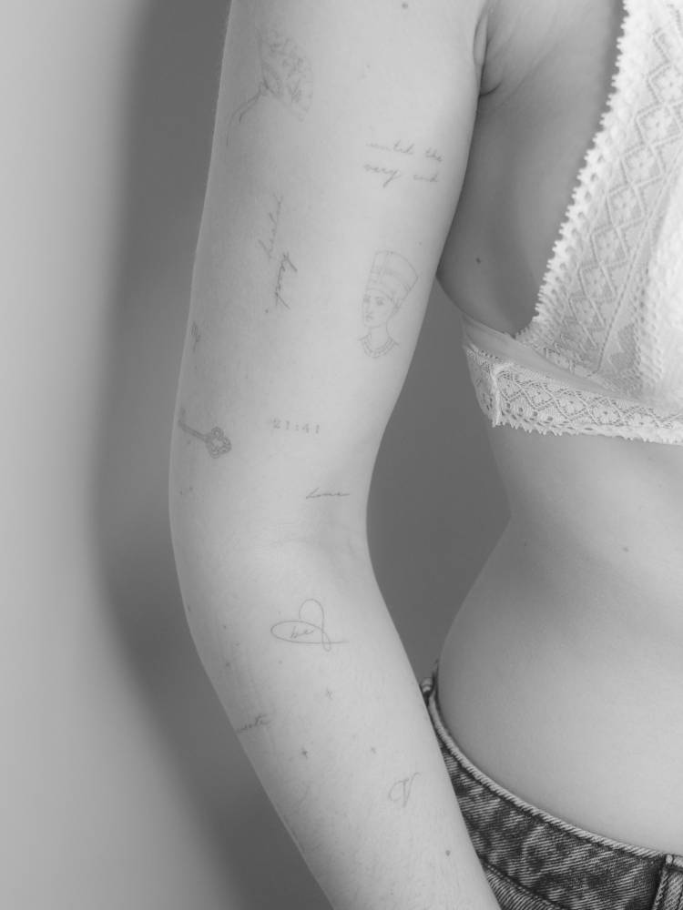 Fine line style arm composition tattoos.