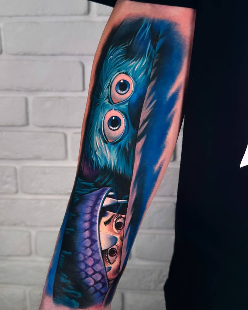 Boo and Sullivan tattoo located on the inner forearm, cartoon style.