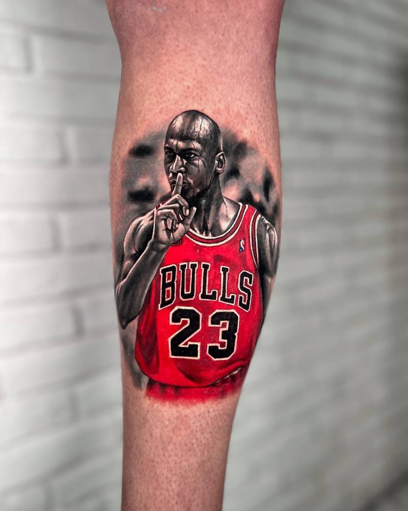 Michael Jordan tattoo located on the calf, realistic style.