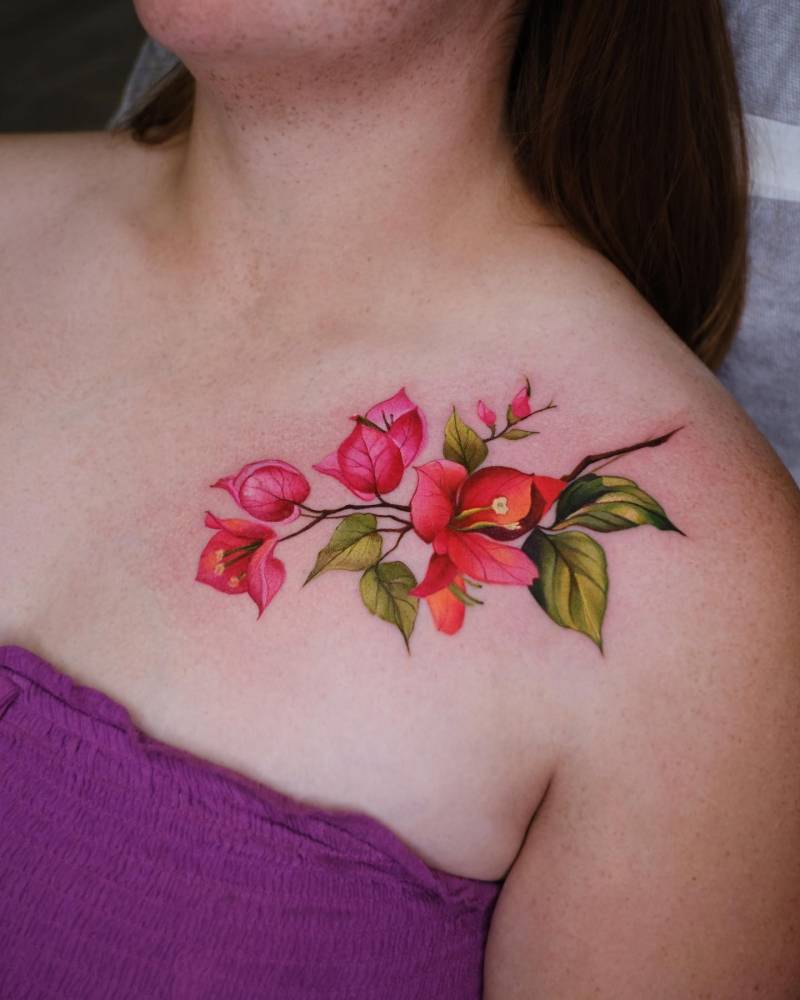 Bougainvillea flowers tattoo in realistic style located on the collarbone.