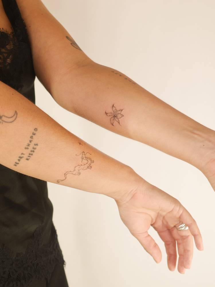 FIne line dragon and orchid flower tattoos.