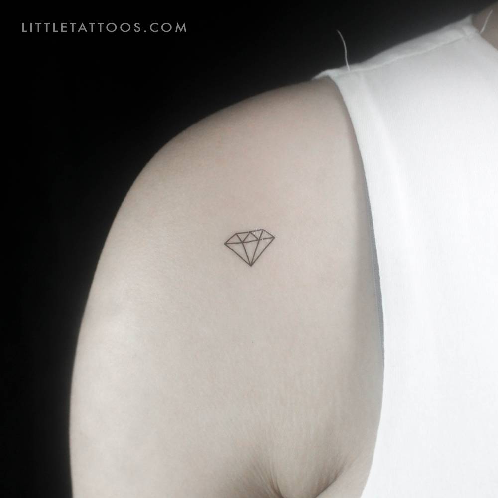 Minimalist little diamond temporary tattoo located on the shoulder.