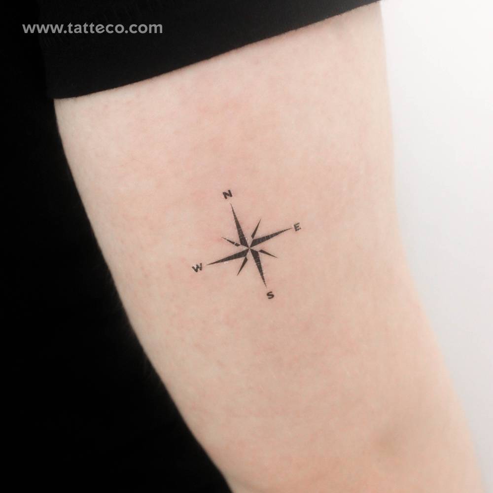 Compass rose temporary tattoo placed on the tricep.