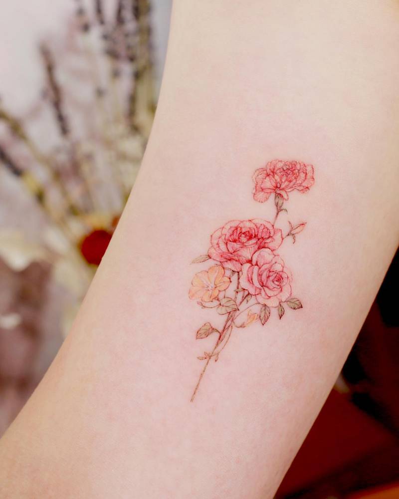 Watercolor style flower bouquet tattoo located on the inner arm.