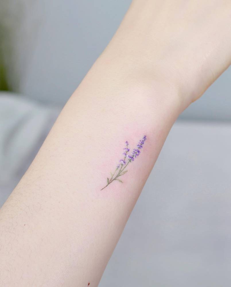Lavender in watercolor tattooed on the wrist.