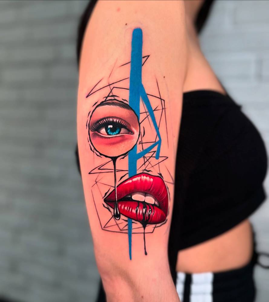 Abstract style woman portrait tattoo located on the upper arm.