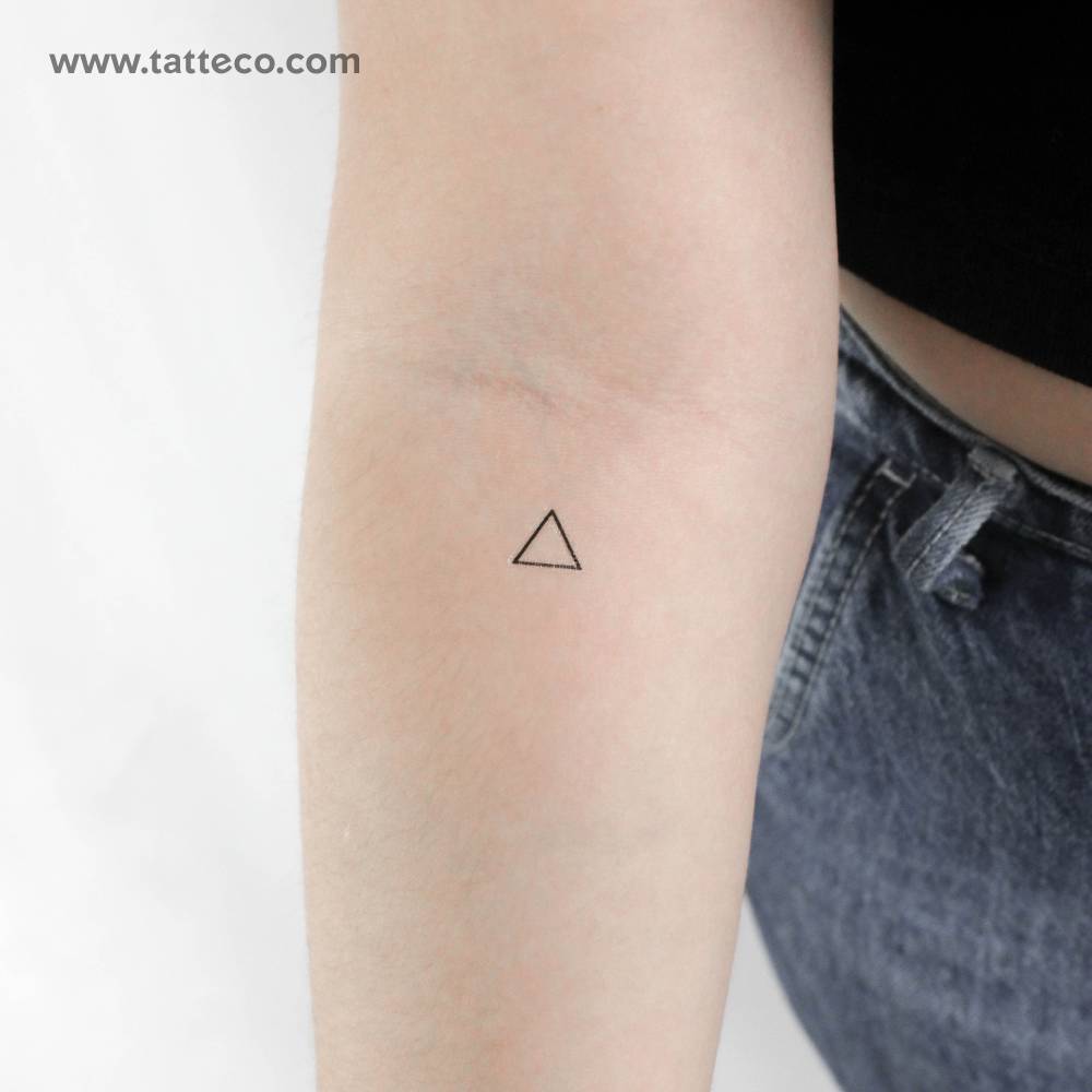 Fire alchemical symbol temporary tattoo located on the inner forearm.