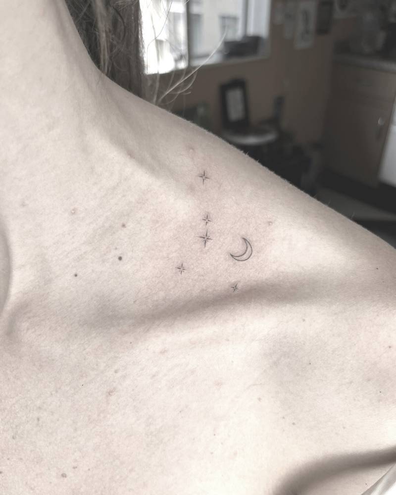 Shining stars and crescent moon done on the top of shoulder.