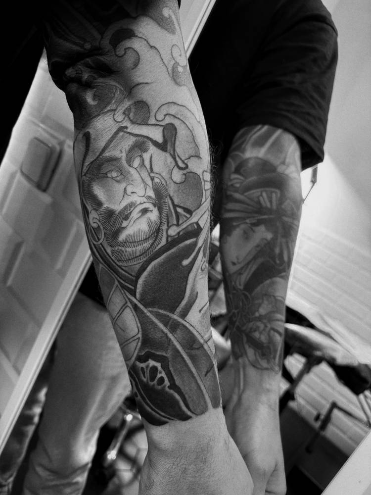 Daruma tattoo in neotraditional style located on the forearm.
