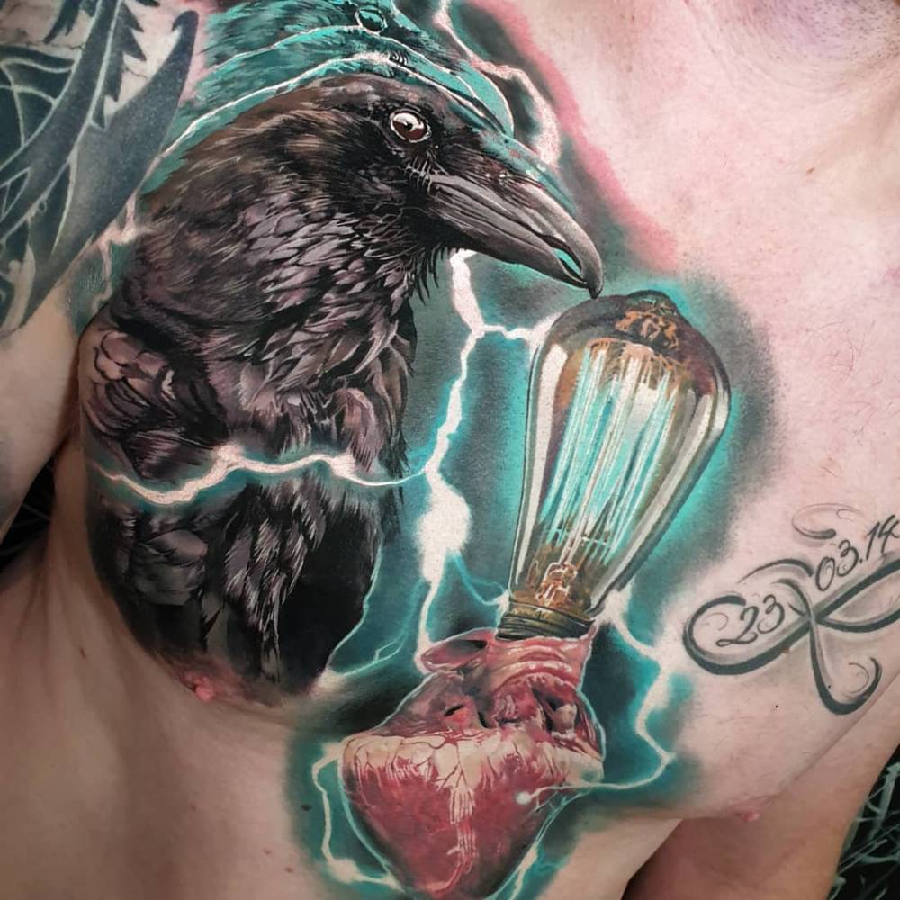 Crow portrait tattoo in realistic style located on the chest.