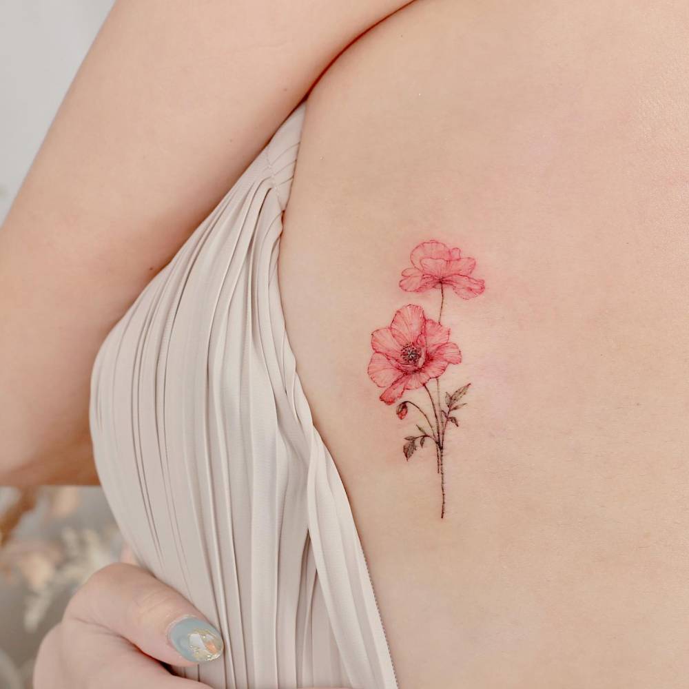 Poppy flowers tattooed on the side boob, watercolor style.