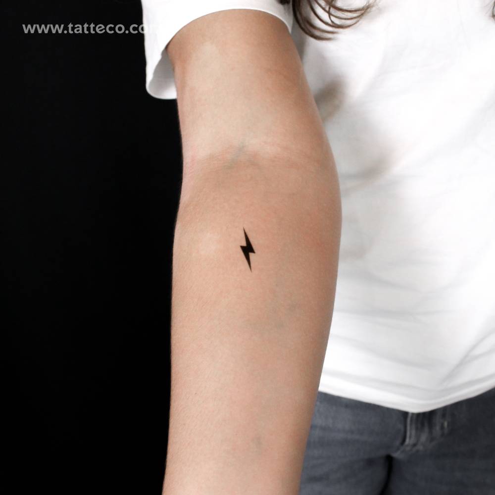 Minimalist black lightning bolt semi-permanent tattoo.