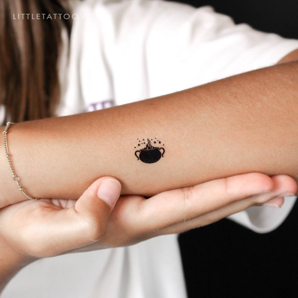 Cauldron temporary tattoo located on the wrist.