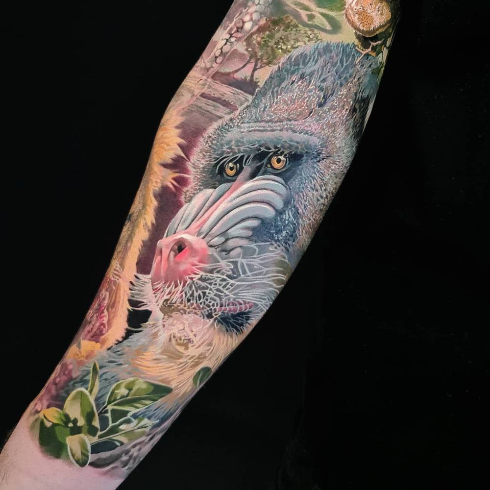 Baboon portrait in realistic style located on the inner forearm.
