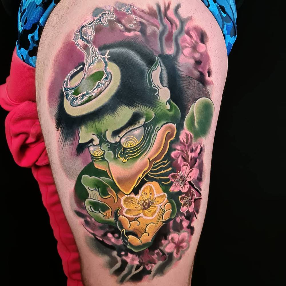 Oriental style Kappa tattoo located on the thigh.