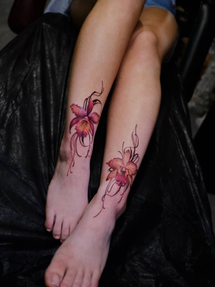 Individual matching orchids tattoo in realistic style.