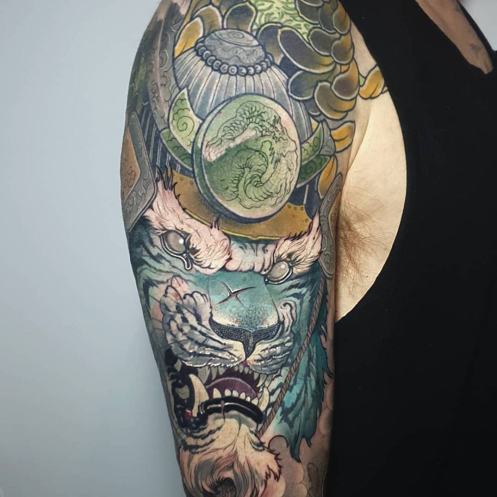 Oriental style samurai tiger tattoo located on the upper arm.