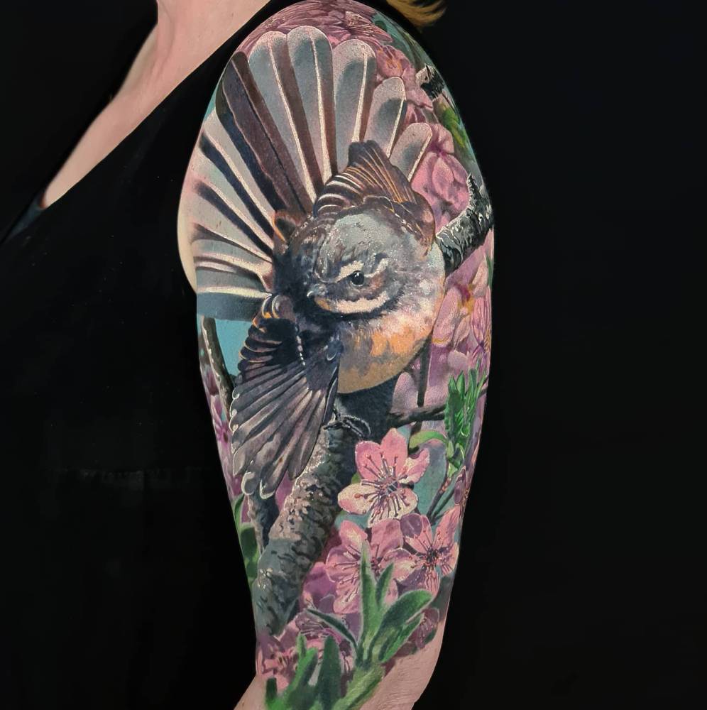 Fantail tattoo located on the upper arm, realistic style.