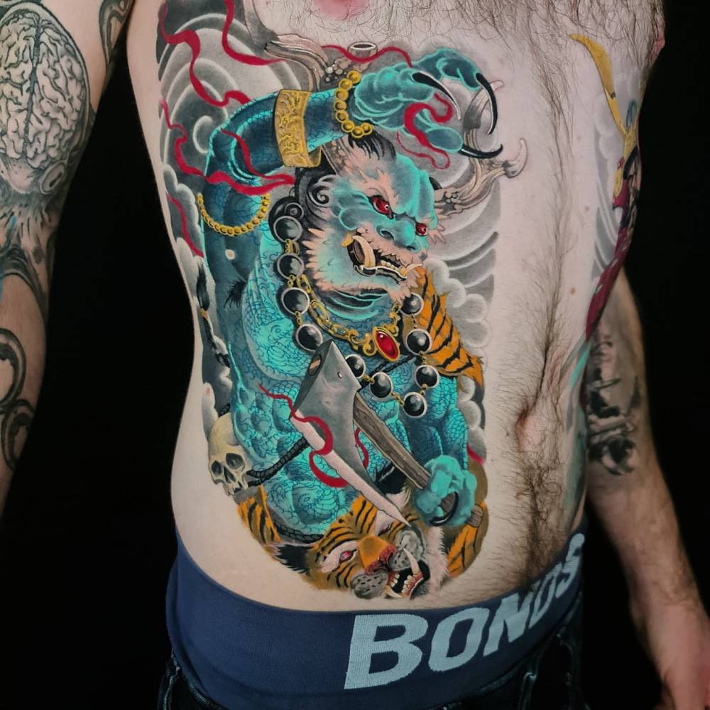 Oni tattoo in oriental style located on the ribs.
