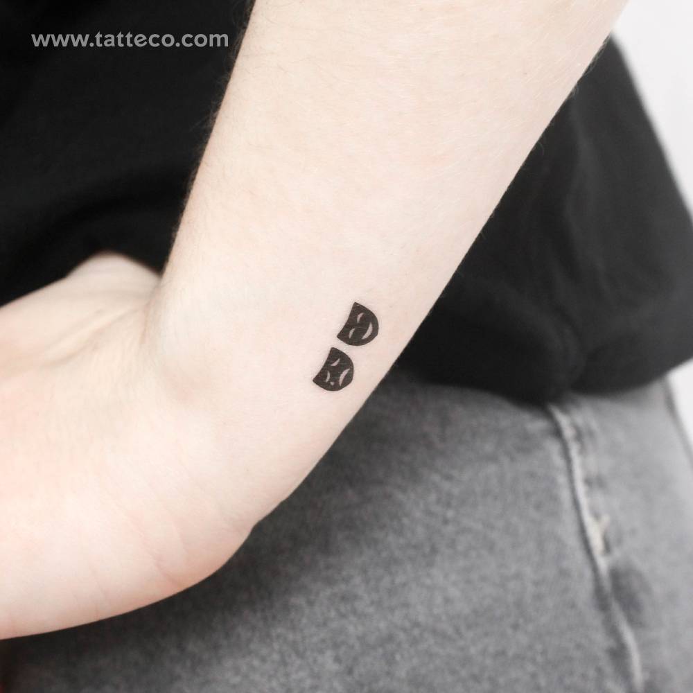 Drama masks temporary tattoo located on the wrist.