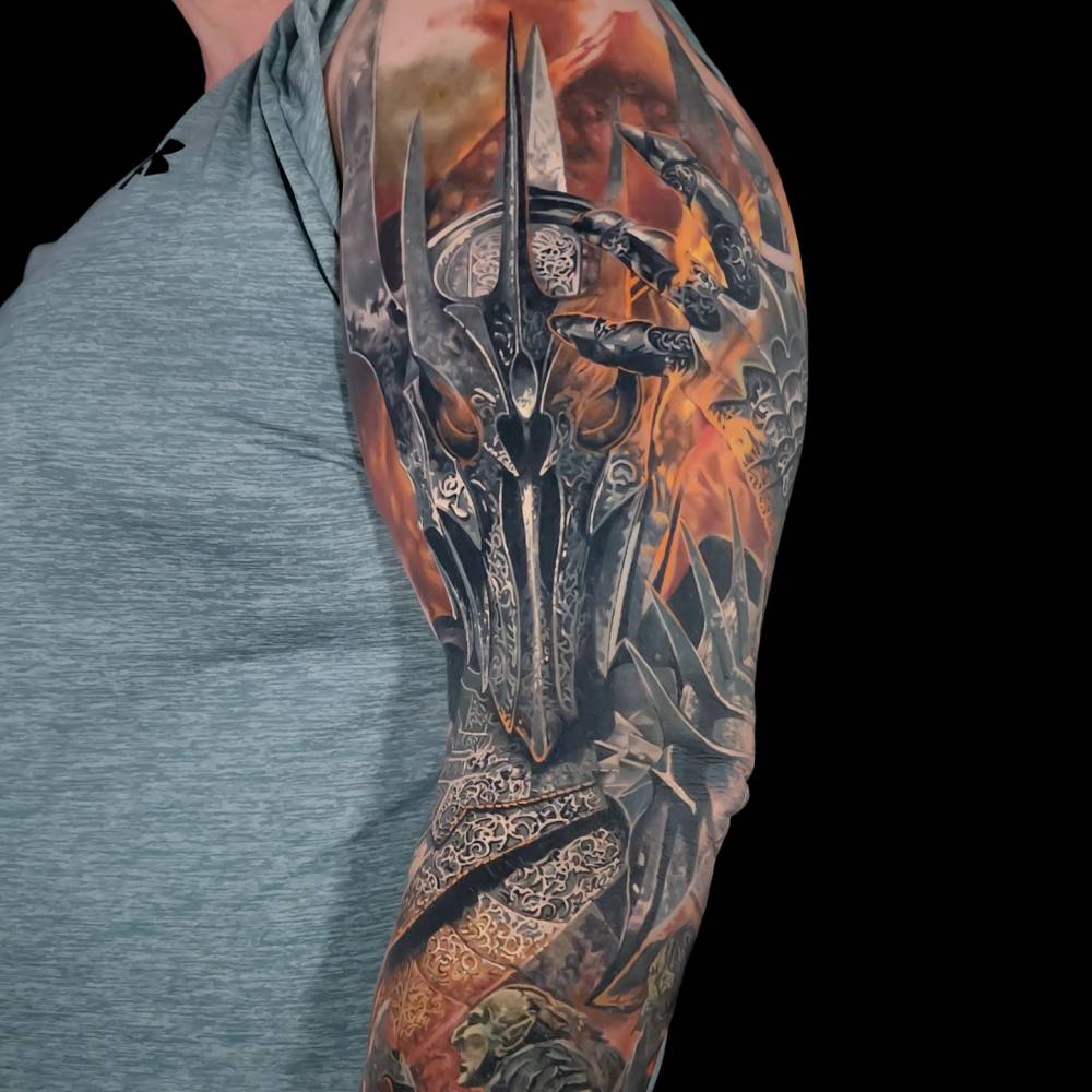 Sauron tattoo in realistic style located on the upper arm.