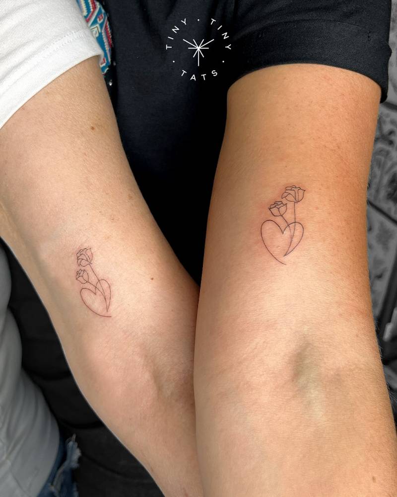 Fine line style matching flowers and heart tattoo for best friends.