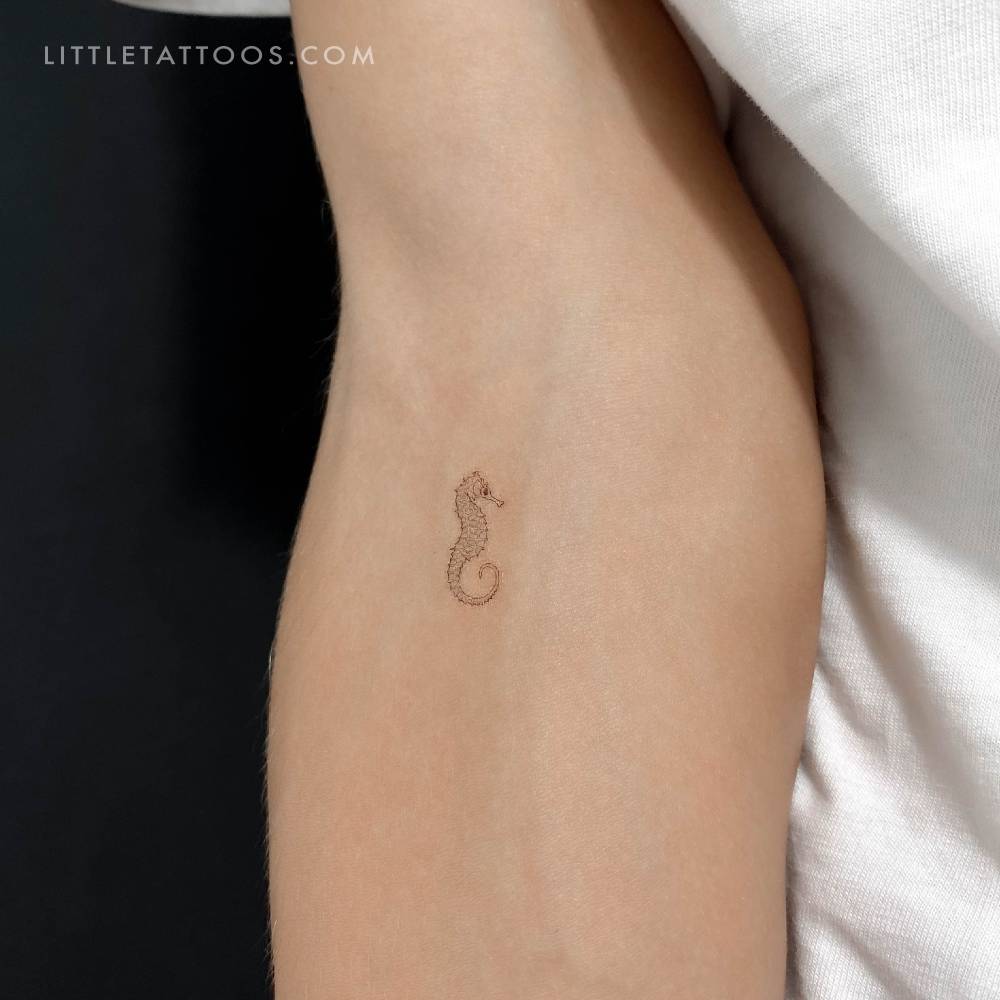 Fine line style seahorse temporary tattoo located on the inner forearm.