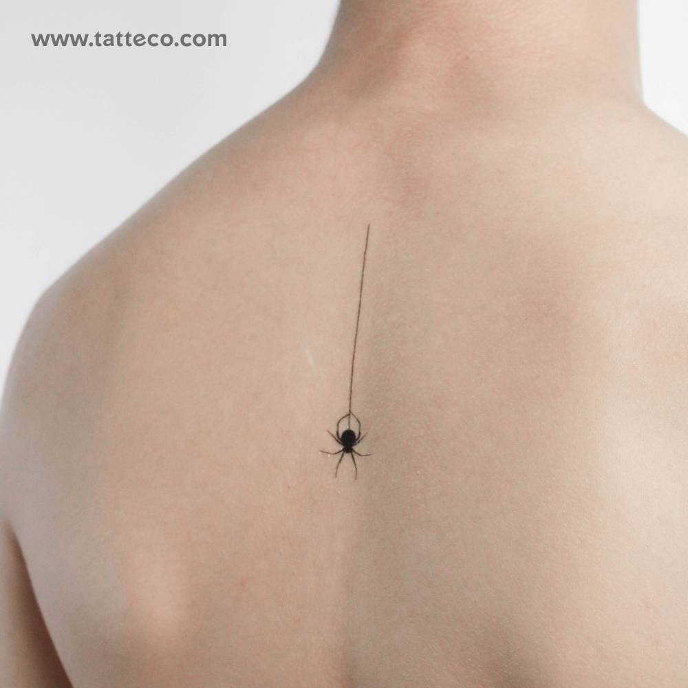 Hanging spider temporary tattoo located on the upper back.