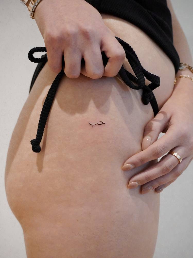 Love in arabic tattoo located on the hip.