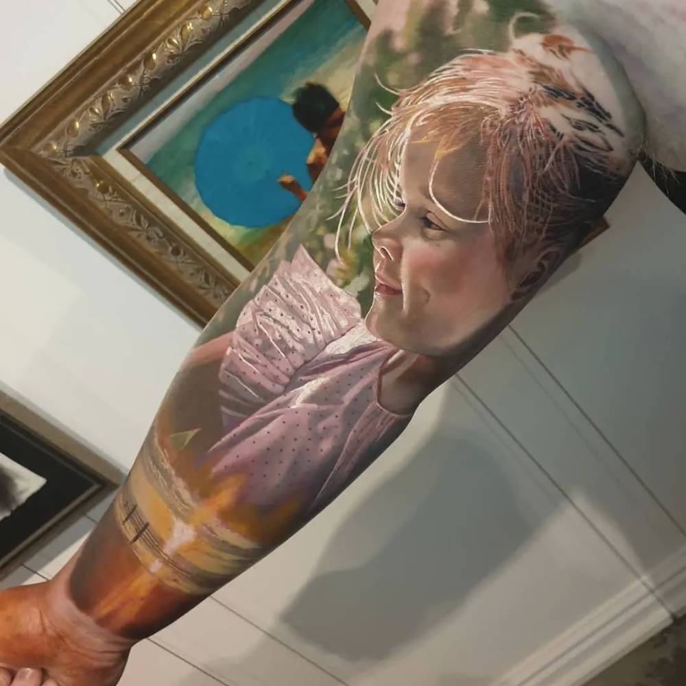 Daughter's portrait tattoo sleeve in realistic style.