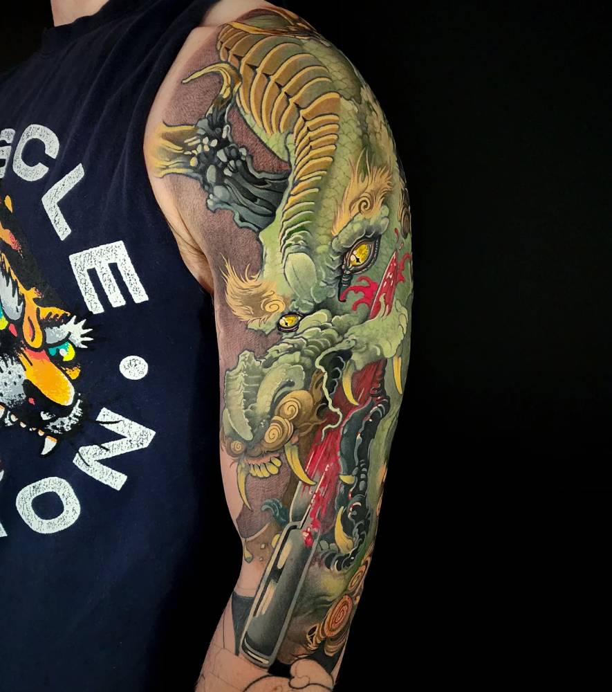 Oriental style dragon tattoo located on the upper arm.