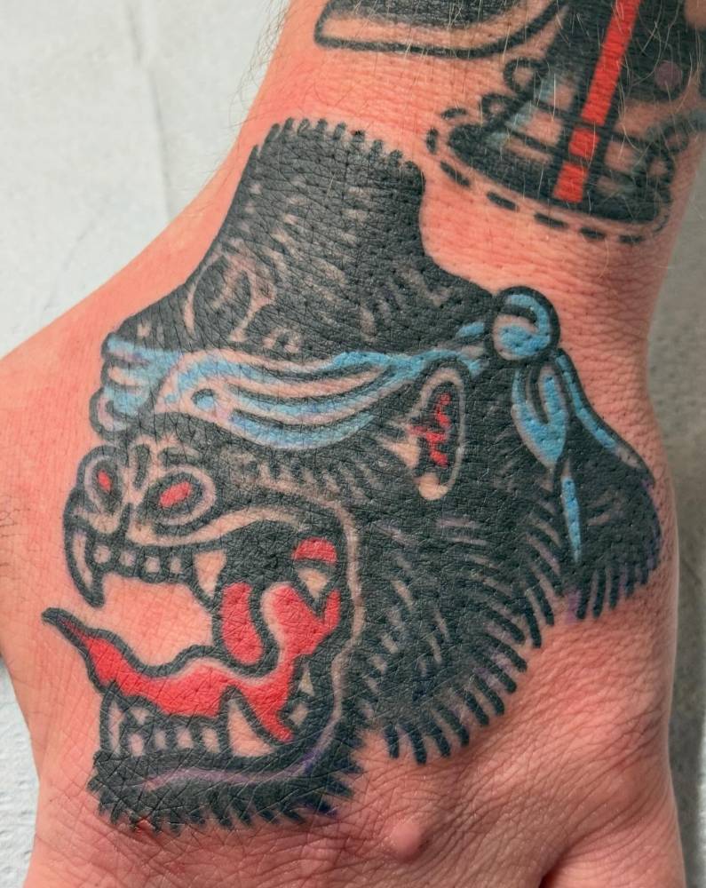 Traditional style gorilla head tattoo done on the hand.