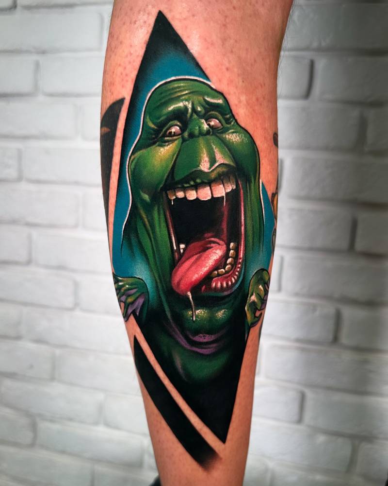 Cartoon style Slimer tattoo located on the calf.