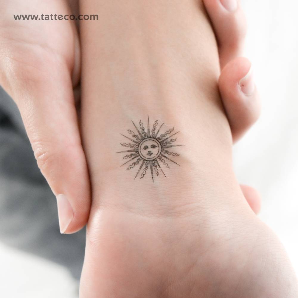 Small inti sun temporary tattoo located on the wrist.