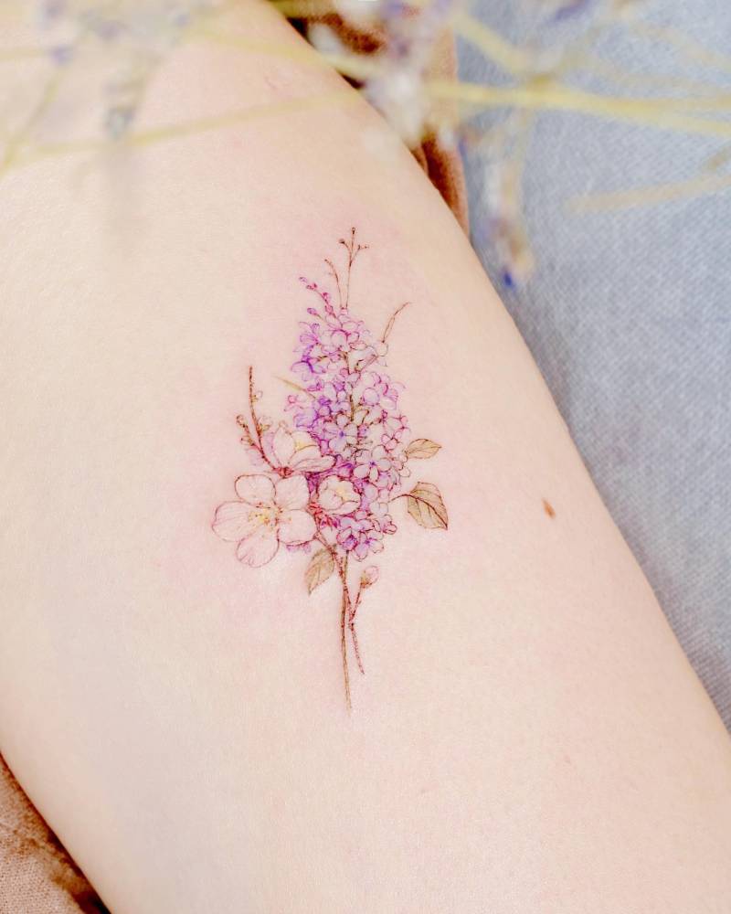 Watercolor style flower bouquet tattoo placed on the inner forearm.