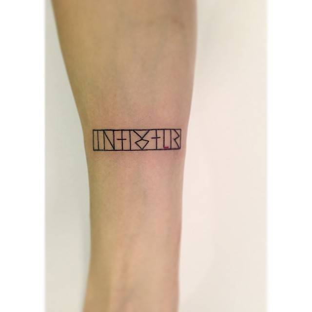 Runes tattoo located on the inner forearm.