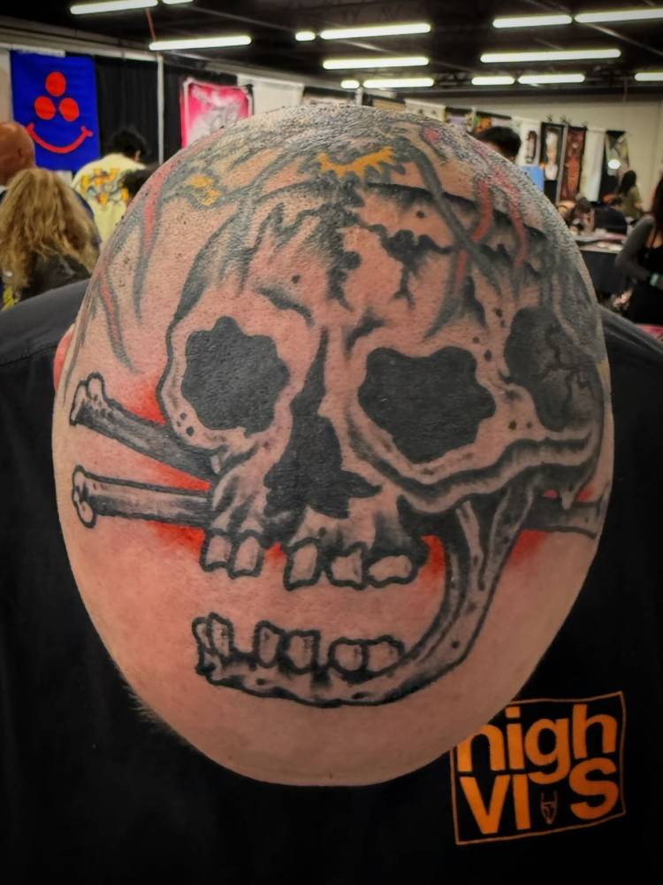 Healed skull tattoo in traditional style located on the head.