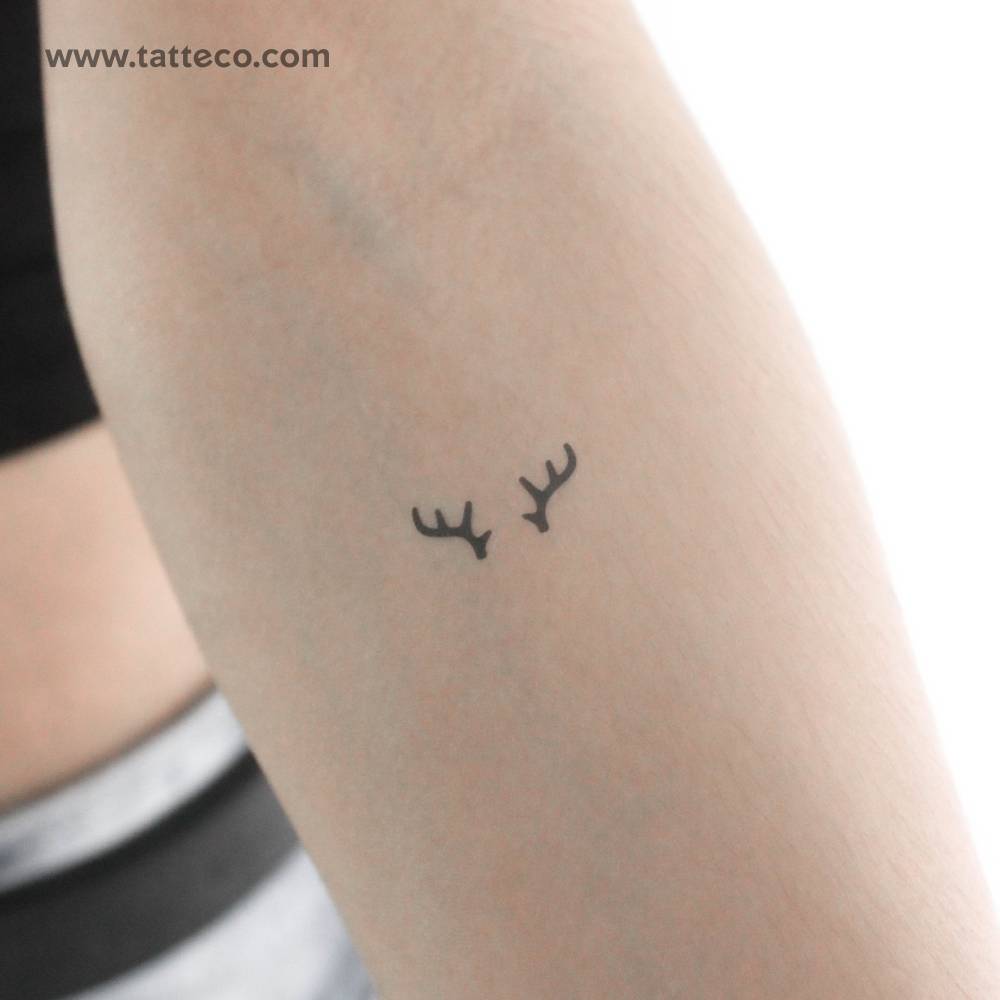 Minimalist antlers temporary tattoo located on the inner forearm.
