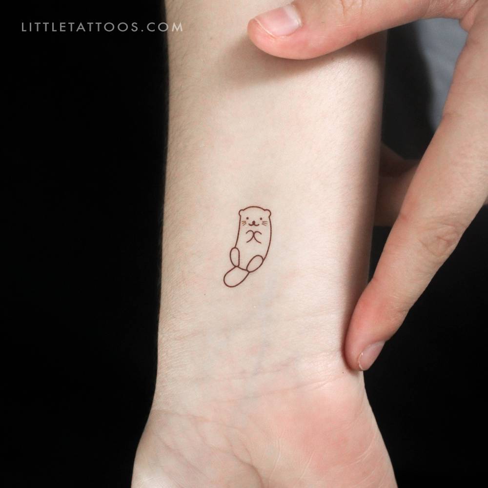 Minimalist otter temporary tattoo located on the wrist.